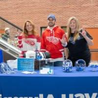 Three Lakers running the booth at the Red Wings game.